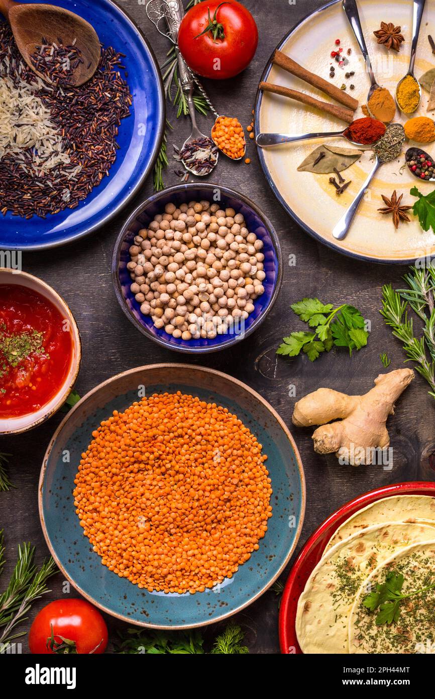 Table served with traditional for asian or eastern cuisine food. Cereal grains, beans, spices on