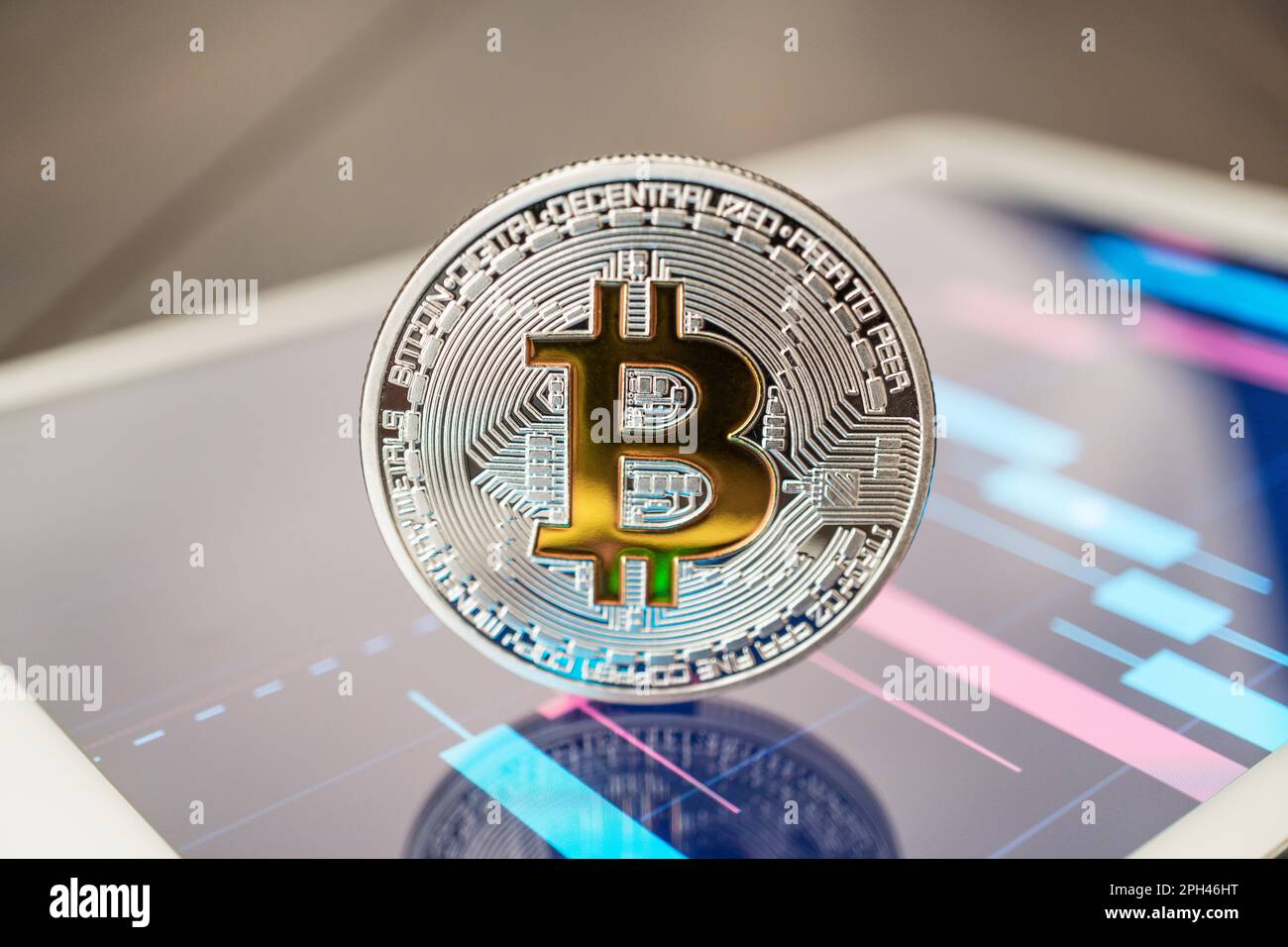 close-up photo of bitcoin cryptocurrency physical coin on the tablet  computer showing stock market charts. trading bitcoin cryptocoin concept on  the w Stock Photo - Alamy