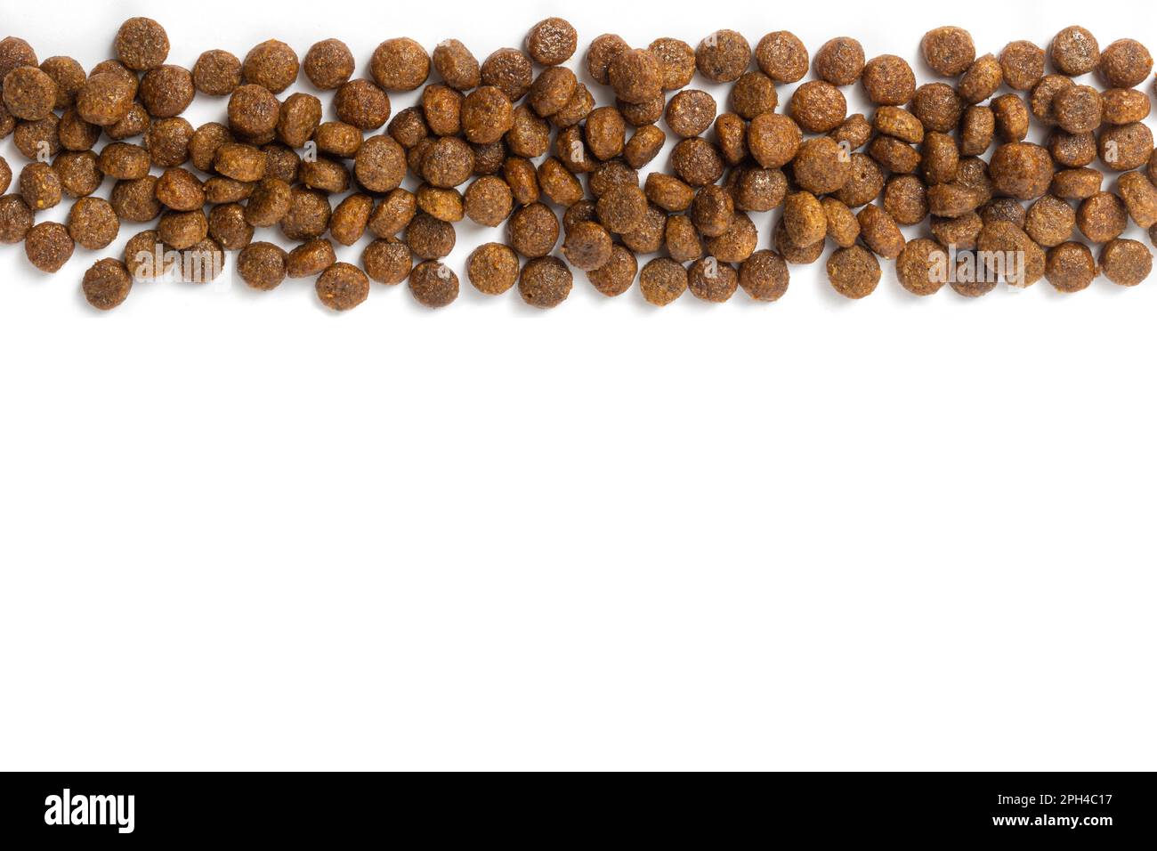 Dry pet food background. Pile of granulated animal feeds on white. Granules of good nutrition for dogs and cats. Stock Photo