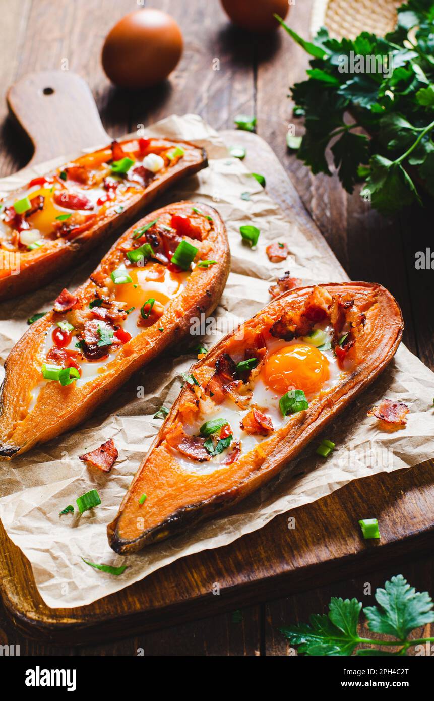 Baked Sweet Potato Stuffed with Egg, Bacon, and Green Onions on Rustic