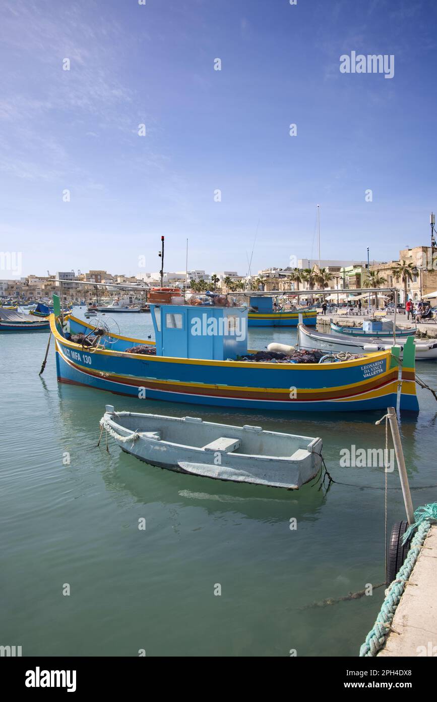 multi coloured boats in the traditional fishing village of marsaxlokk ...