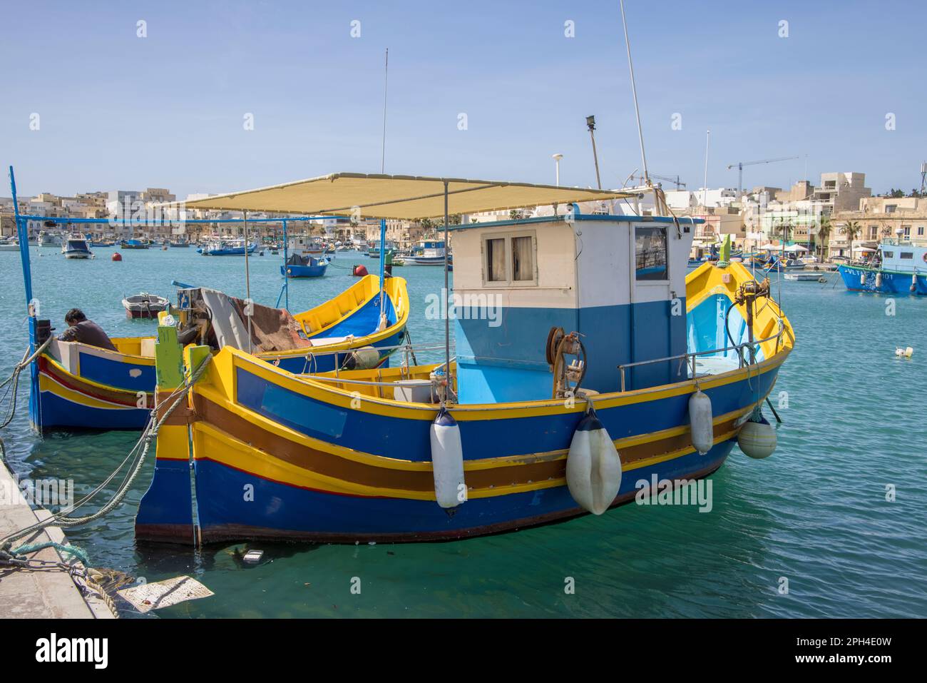 multi coloured boats in the traditional fishing village of marsaxlokk ...