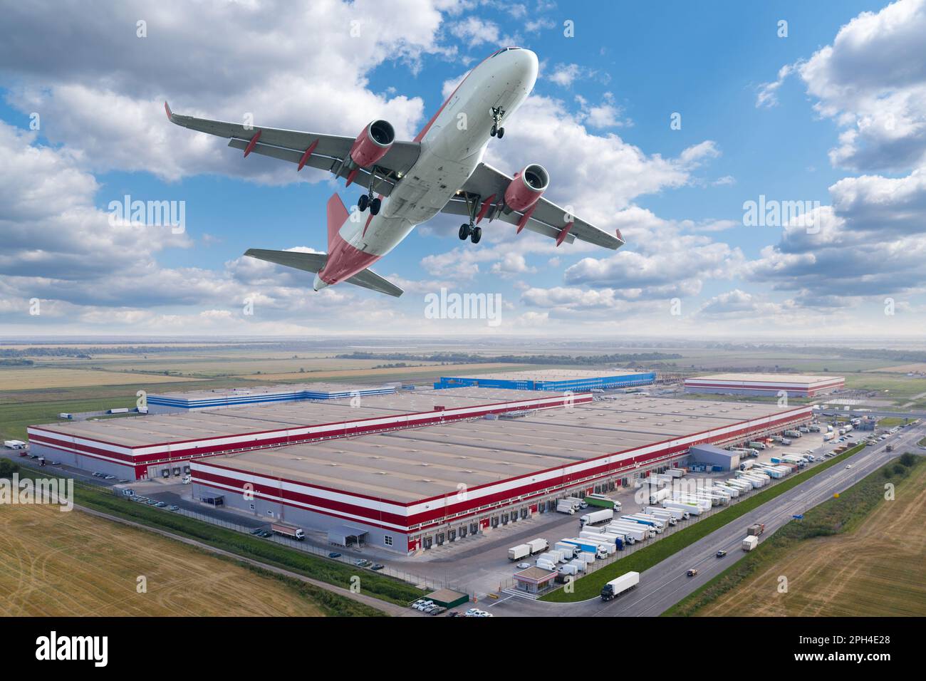 Airplane in the sky above the logistic center. World trade and transportation concept. High quality photo Stock Photo