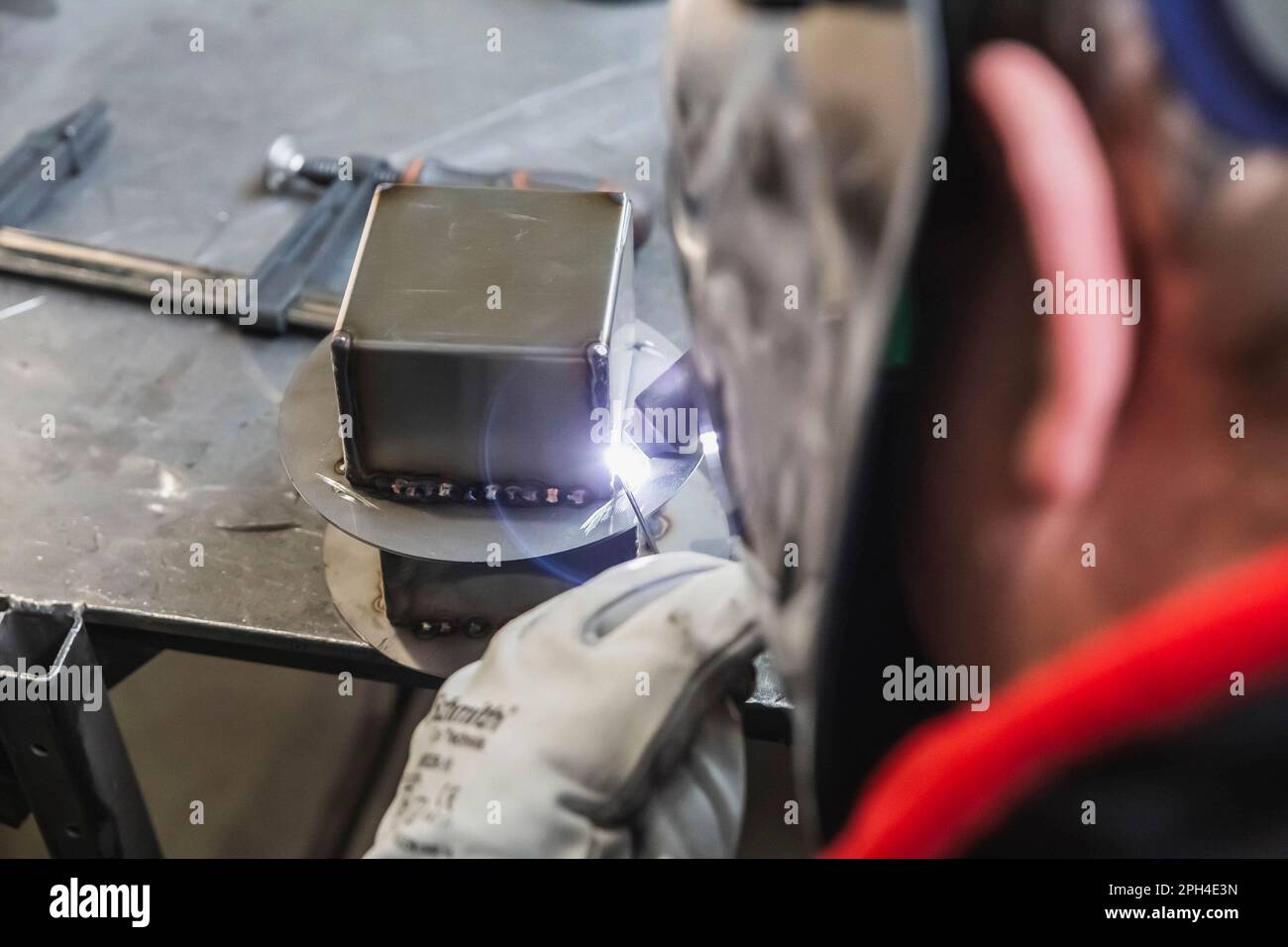 employee works by Semiautomatic argon welding at the factory Stock