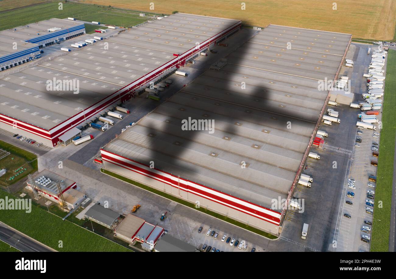 Shadow of airplane on a logistic center. World trade and transportation concept Stock Photo