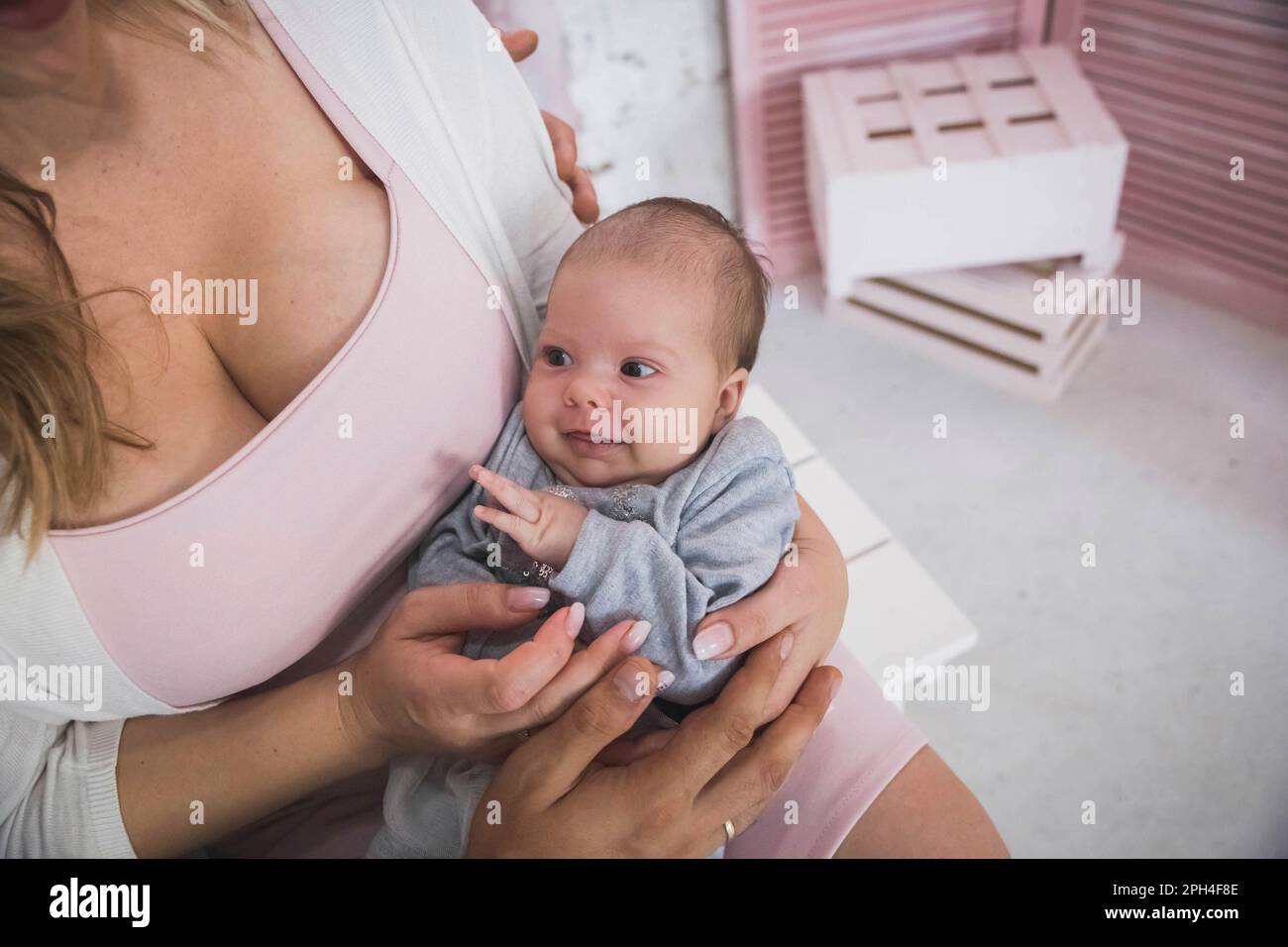 married couple holds in arms tiny smiling daughter Stock Photo
