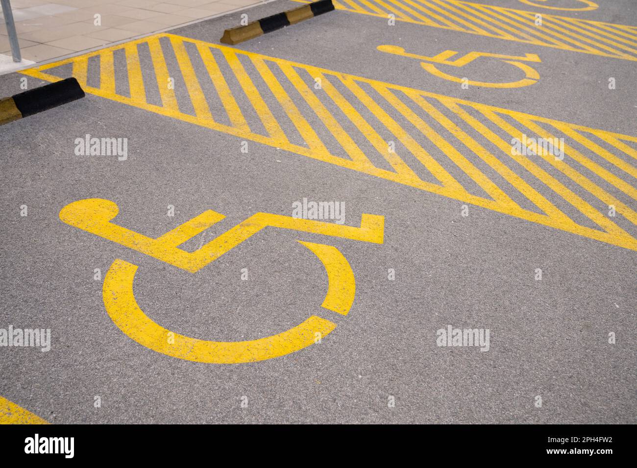 Parking lot for disabled with yellow symbol. High quality photo Stock Photo