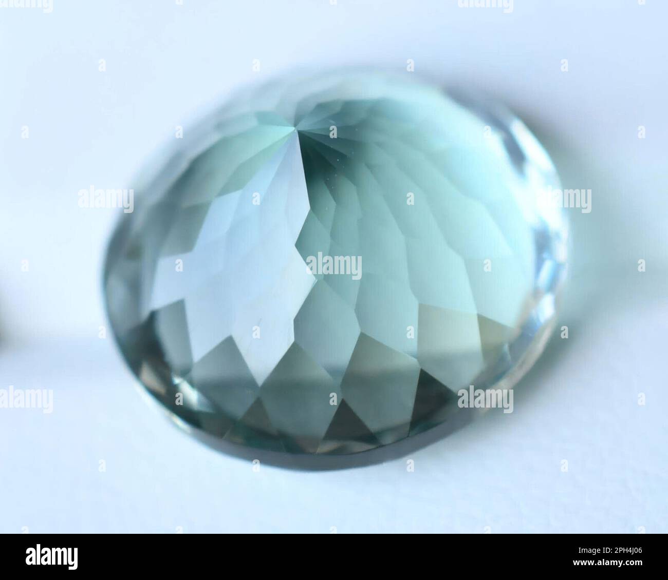 Natural gemstone green blue amblygonite isolated on white background