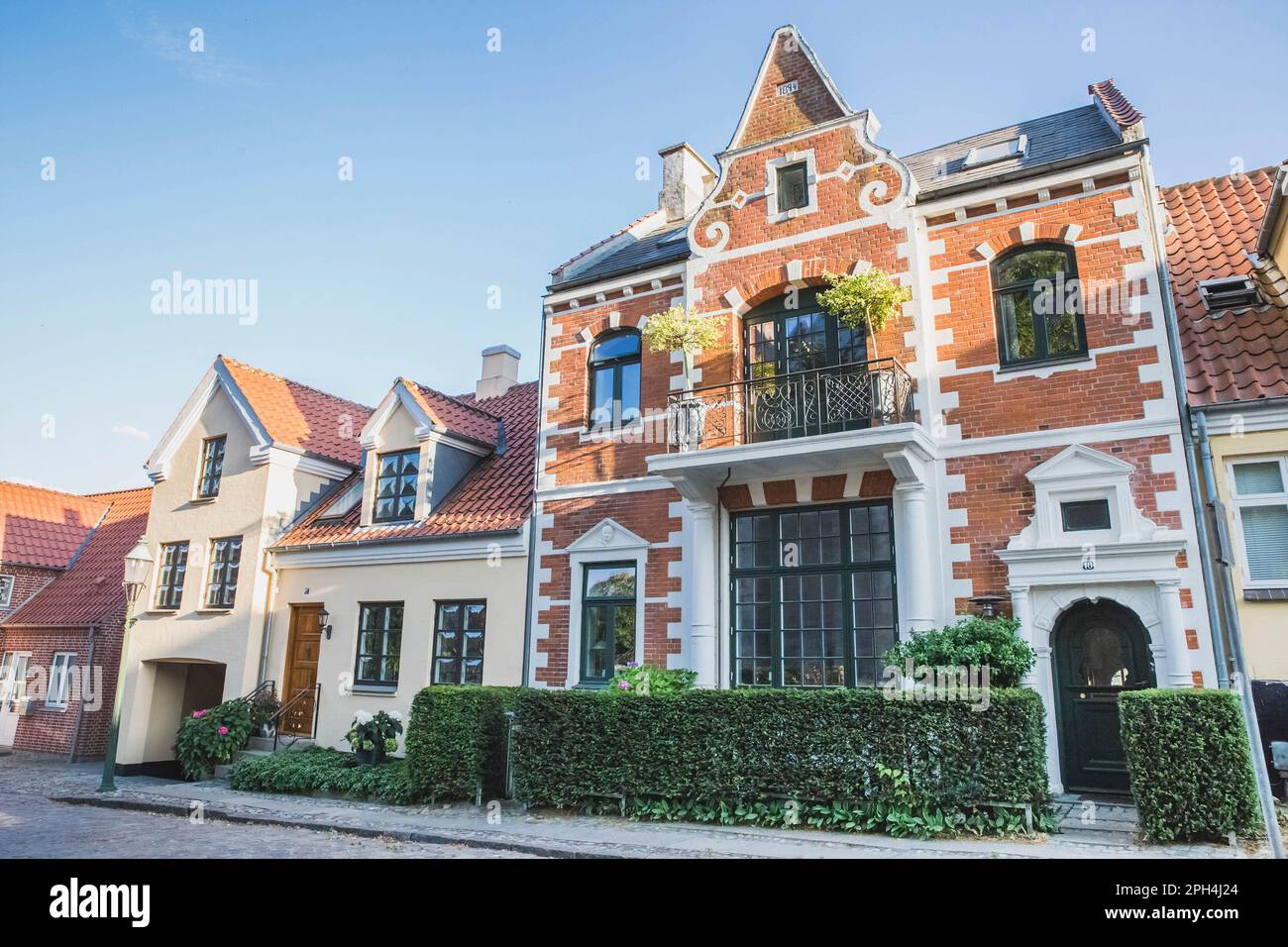 Cozy twostory houses with hedges in Denmark Stock Photo Alamy