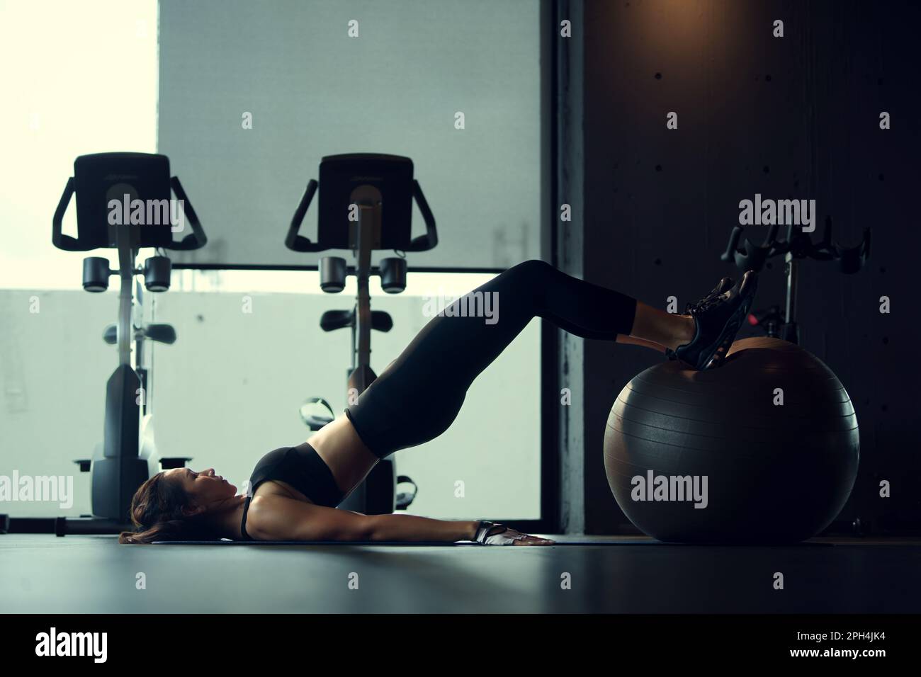 Young woman pilates training in the gym. Stock Photo