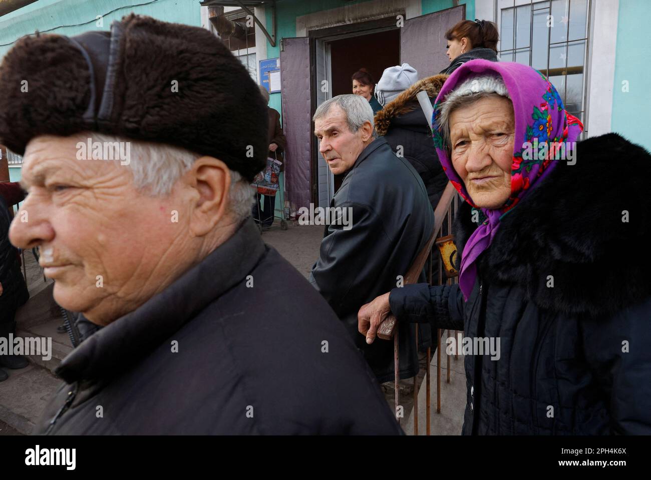 Local residents gather to receive aid delivered by volunteers in the course of Russia-Ukraine conflict in the settlement of Nyzhnie, in the Luhansk region, Russian-controlled Ukraine, March 24, 2023. REUTERS/Alexander Ermochenko Stock Photo