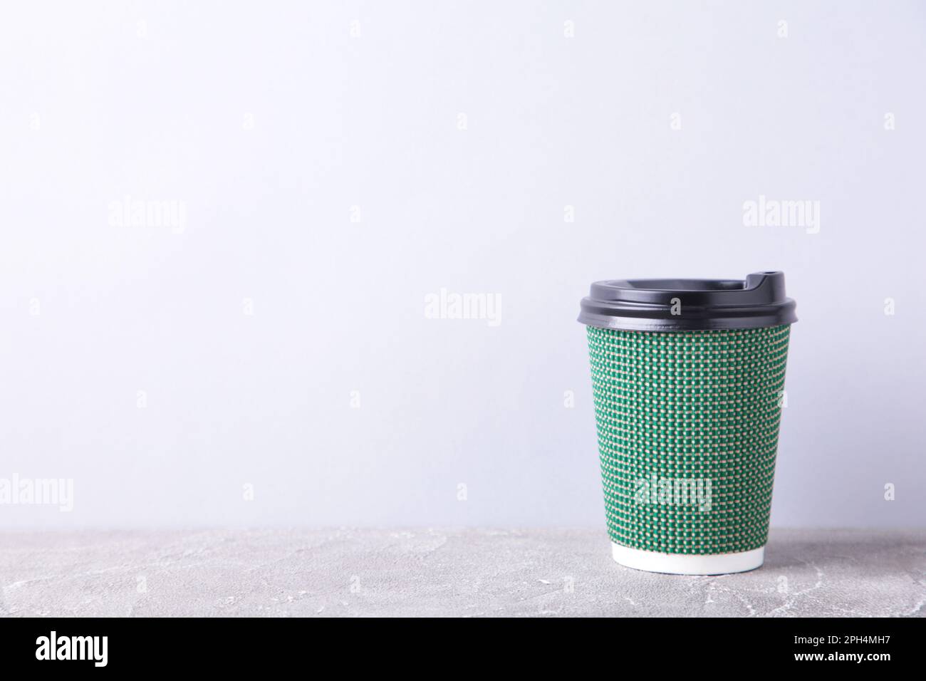 Green paper cup of coffee on grey background, cut out Stock Photo - Alamy