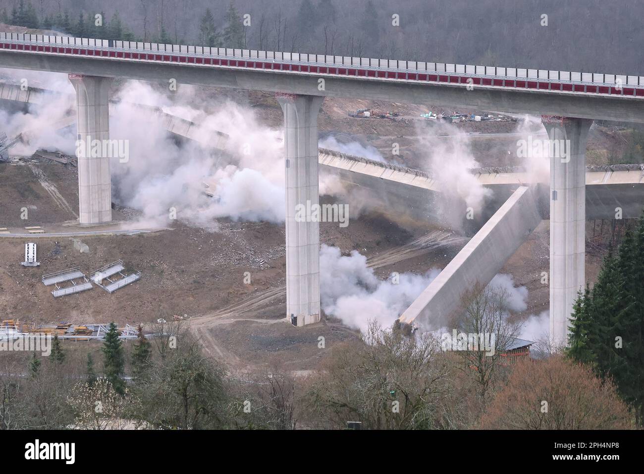 Siegen, Germany. 26th Mar, 2023. Explosions at the bottom of the bridge piers during the blasting of the southern bridge of the A45 Eisern viaduct. The bridge tilts to the side as planned. Credit: David Young/dpa/Alamy Live News Stock Photo
