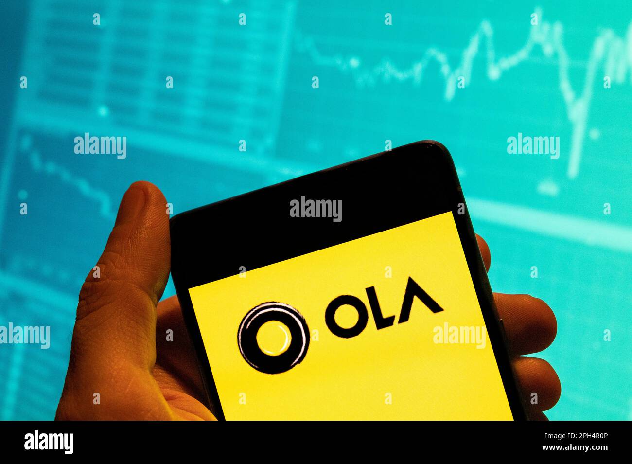 Person holding mobile phone with logo of Indian ridesharing company Ola Cabs  on screen in front of business web page. Focus on phone display Stock Photo  - Alamy