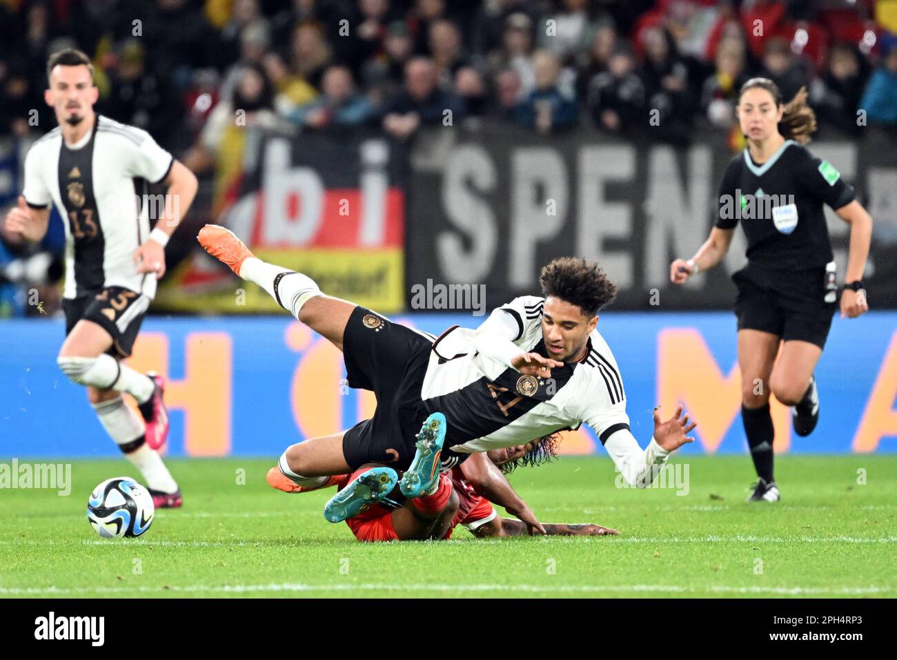 Mainz, Germany. 25th Mar, 2023. Soccer: International match, Germany - Peru, at Mewa Arena. Germany's Kevin Schade (r) and Peru's Renato Tapia fight for the ball. Credit: Federico Gambarini/dpa/Alamy Live News Stock Photo