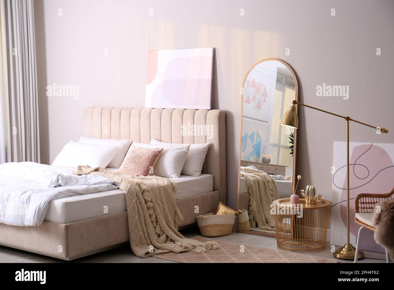 Modern bedroom interior with large stylish mirror and comfortable ...