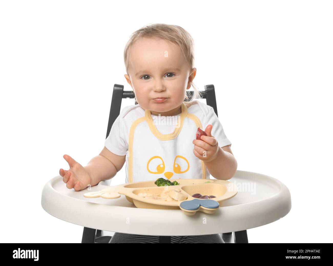 Cute little baby wearing bib while eating on white background Stock ...