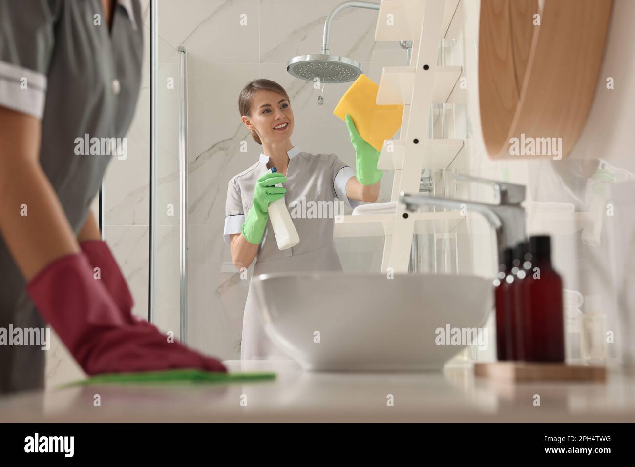 Professional chambermaids cleaning up bathroom in hotel Stock Photo Alamy