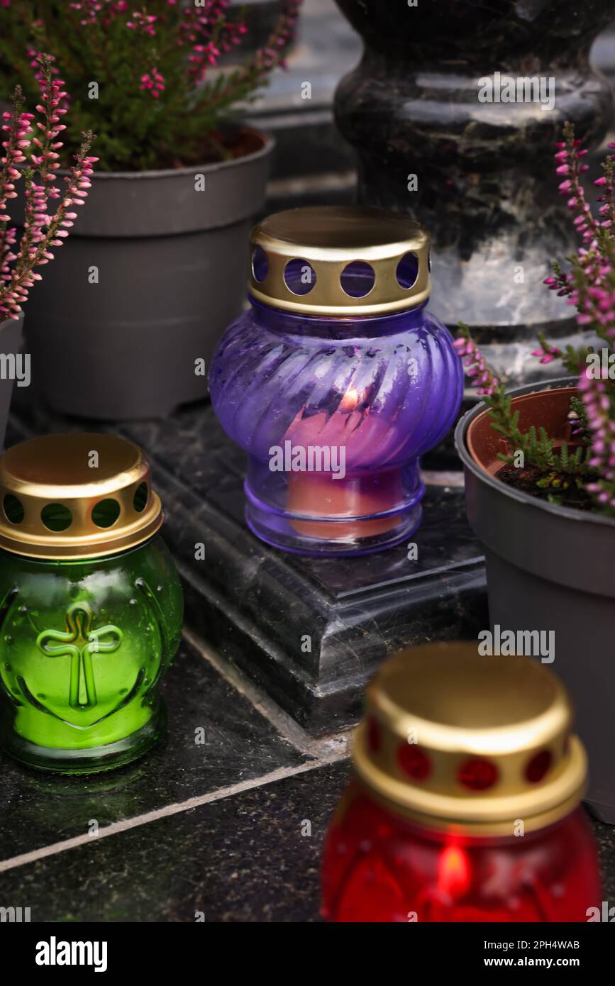 Different grave lanterns on granite surface at cemetery Stock Photo - Alamy