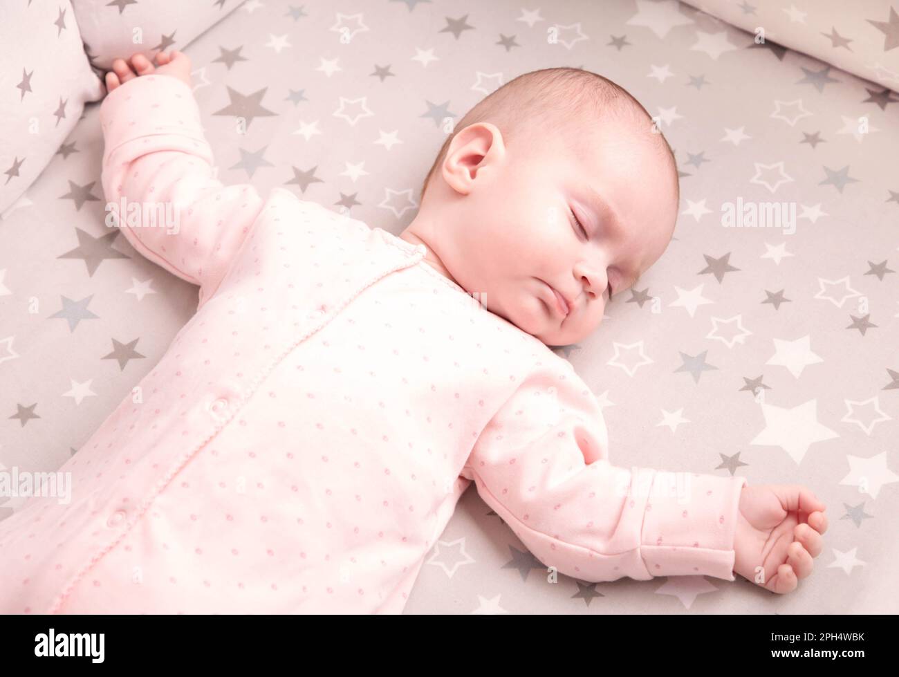 Peaceful baby lying on a bed while sleeping Stock Photo Alamy