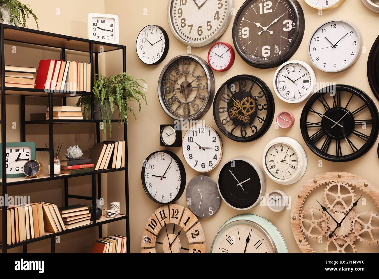 Stylish room interior with collection of wall clocks Stock Photo Alamy