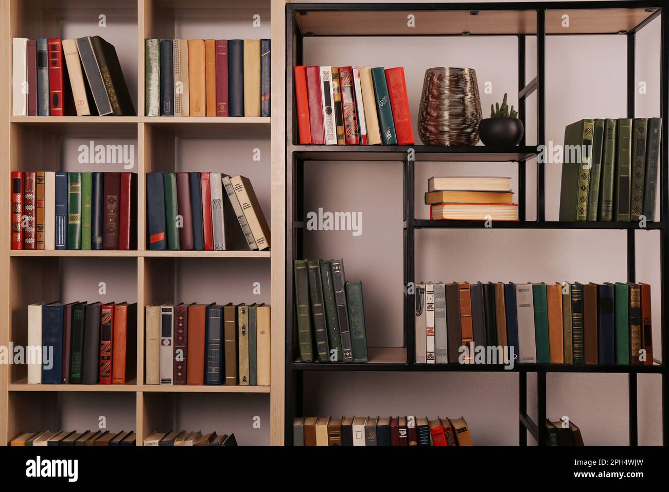 Collection of different books on shelves in home library Stock Photo ...