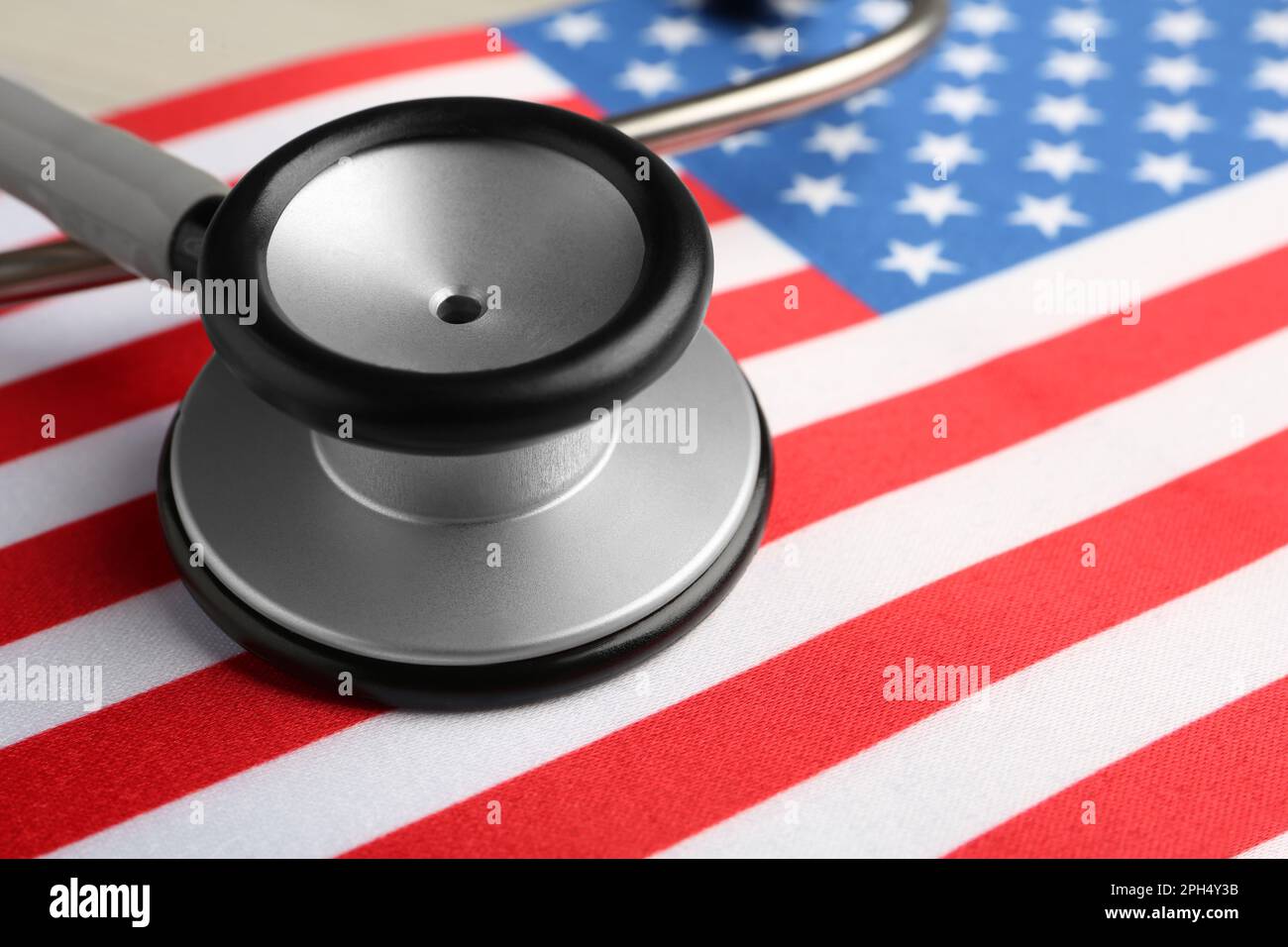 Stethoscope on American flag, closeup. USA medicine and health care