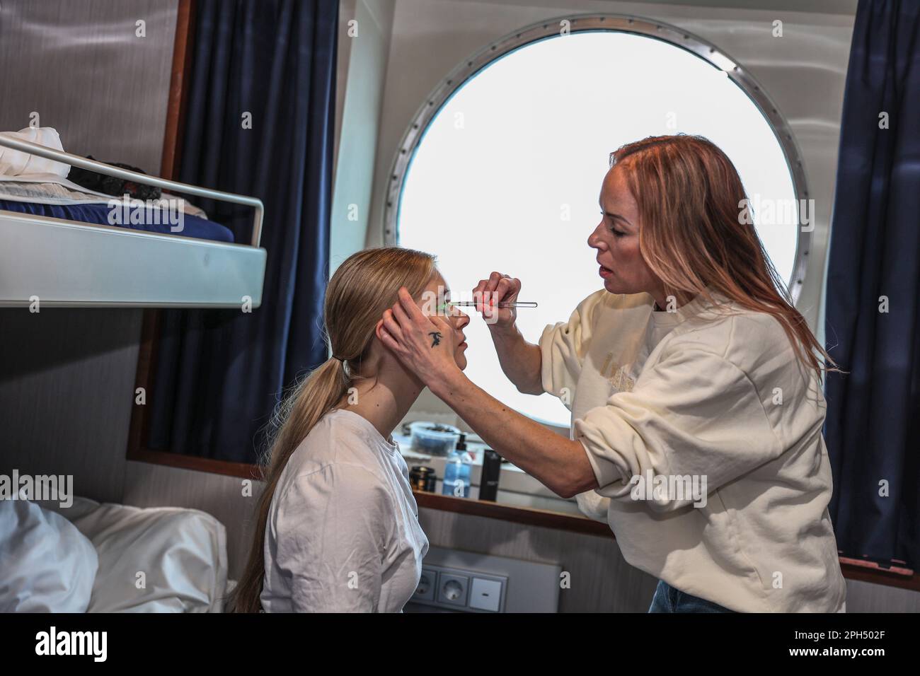 Helsinki, Finland. 24th Mar, 2023. Makeup artist stylist preparing model for fashion show. 26th March 2023 Eckero Line ship company organized Fashion Festival on the Finlandia ship that runs between Helsinki and Tallinn. The Fashion Festival has been realized in cooperation with Ivana Helsinki, piloted by Paola Suhonen. (Photo by Takimoto Marina/SOPA Images/Sipa USA) Credit: Sipa USA/Alamy Live News Stock Photo