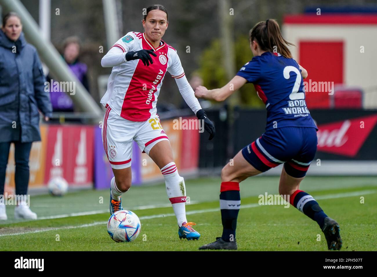 Amsterdam, Netherlands. 26th Mar, 2023. AMSTERDAM, NETHERLANDS - MARCH 26: Quinty Sabajo of Ajax battles for the ball with Ginia Caprino of VV Alkmaar during the Azerion Eredivisie Vrouwen match between Ajax and vv Alkmaar at Sportcomplex De Toekomst on March 26, 2023 in Amsterdam, Netherlands (Photo by Jeroen Meuwsen/Orange Pictures) Credit: Orange Pics BV/Alamy Live News Stock Photo