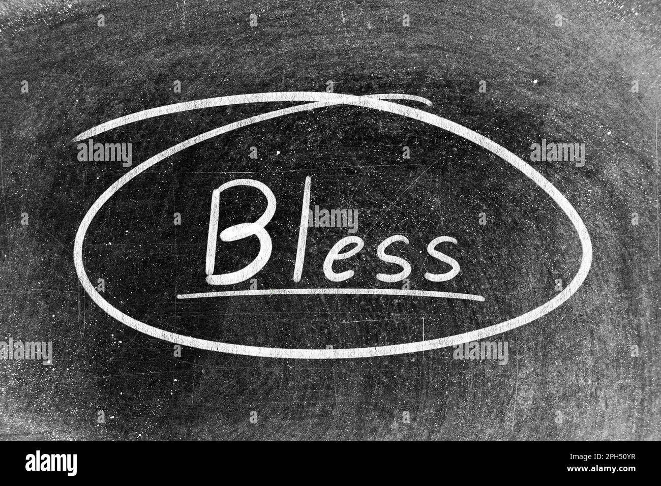 White chalk hand writing in word bless and circle shape on blackboard ...