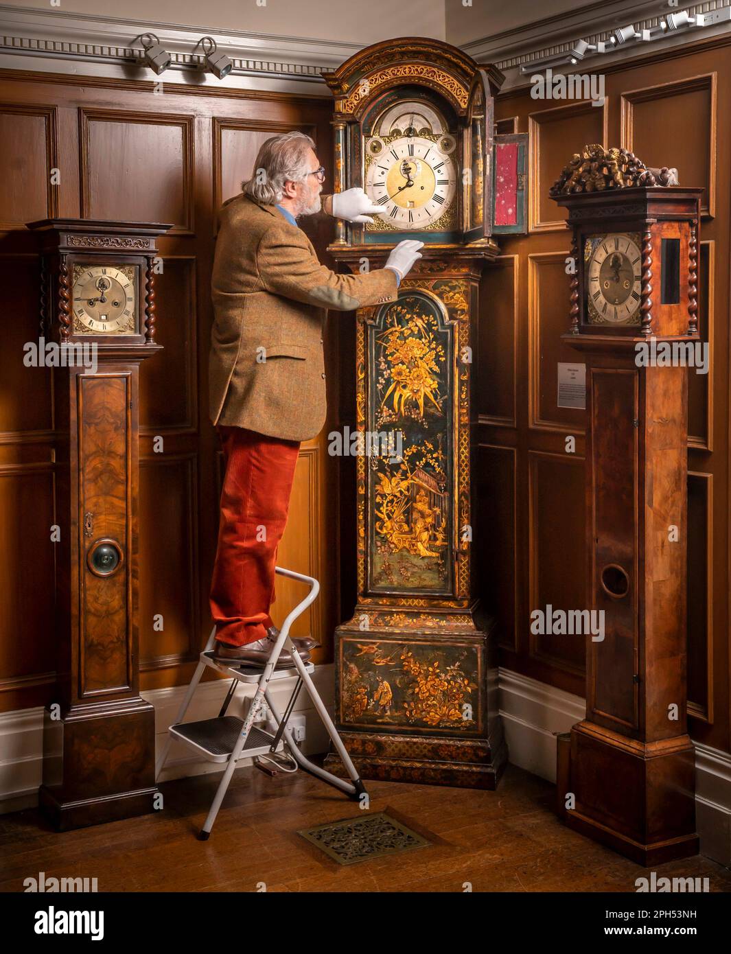 President of the British Horological Institute Alan Midleton, adjusts