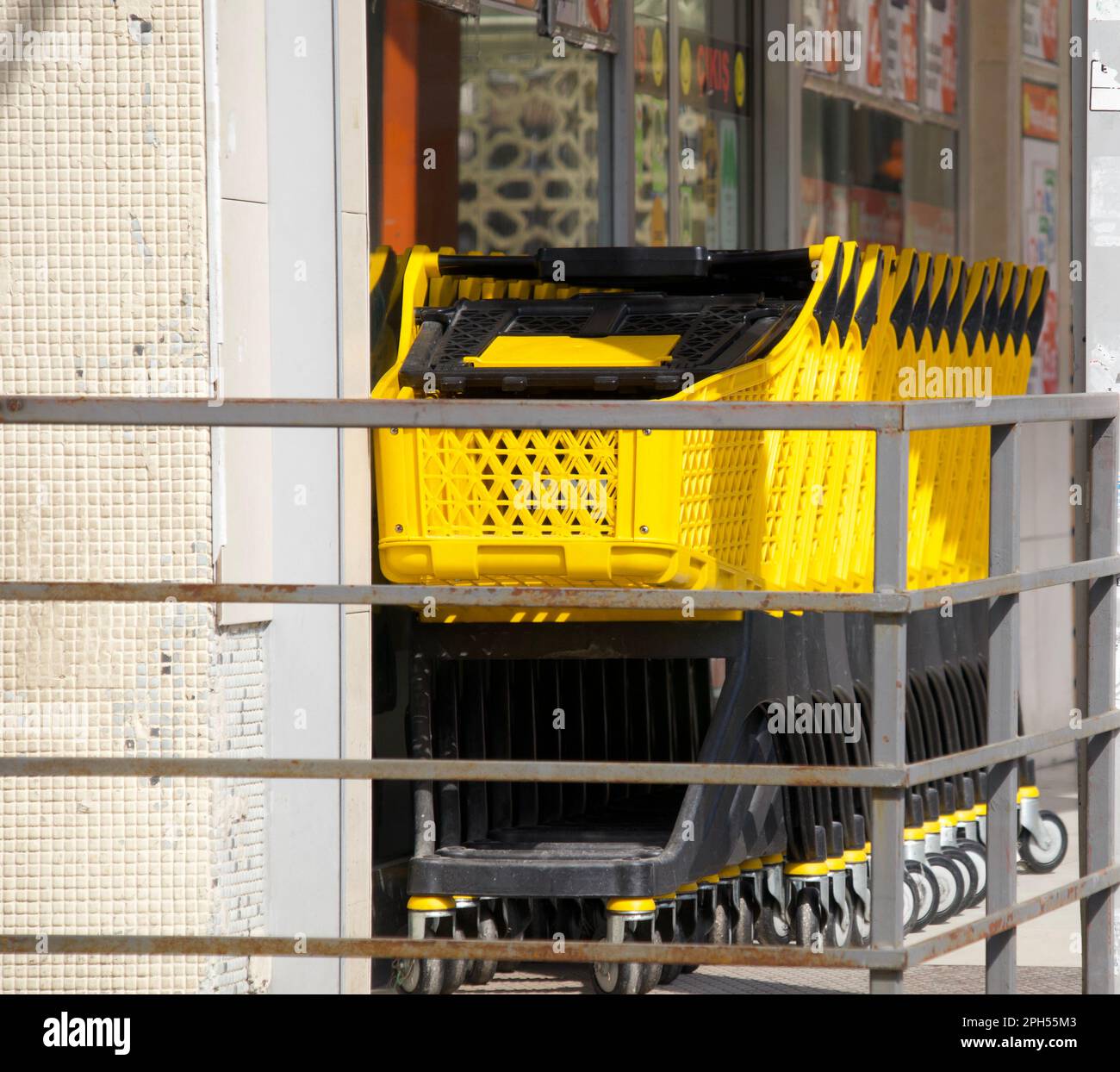 Yellow coloured Shopping carts in front of the market Stock Photo Alamy
