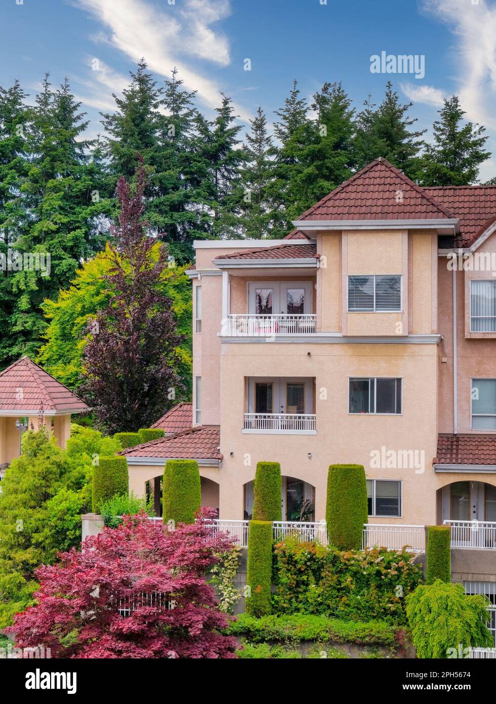 Italian style low-rise residential building with decorative trees ...