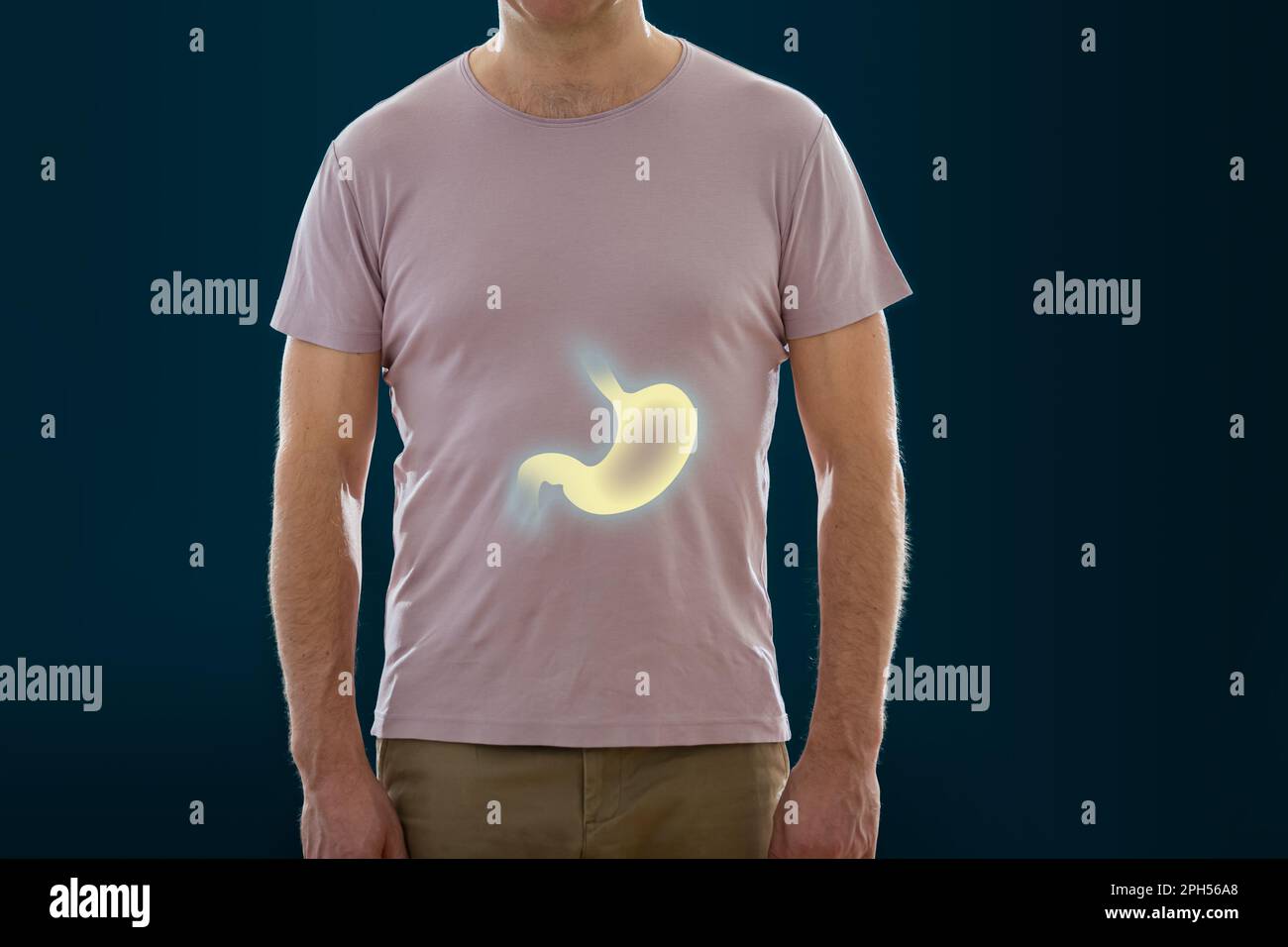 The man standing on a dark background. Picture of a human digestive system and bowel. Anatomy of