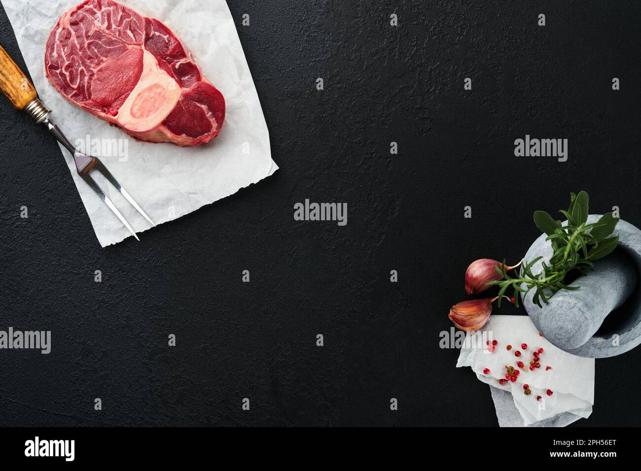 Osso Buco raw steak meat. Barbecue meat. Raw fresh cross cut veal shank and seasonings pepper, rosemary, thyme and salt on dark background. Beef Leg S Stock Photo