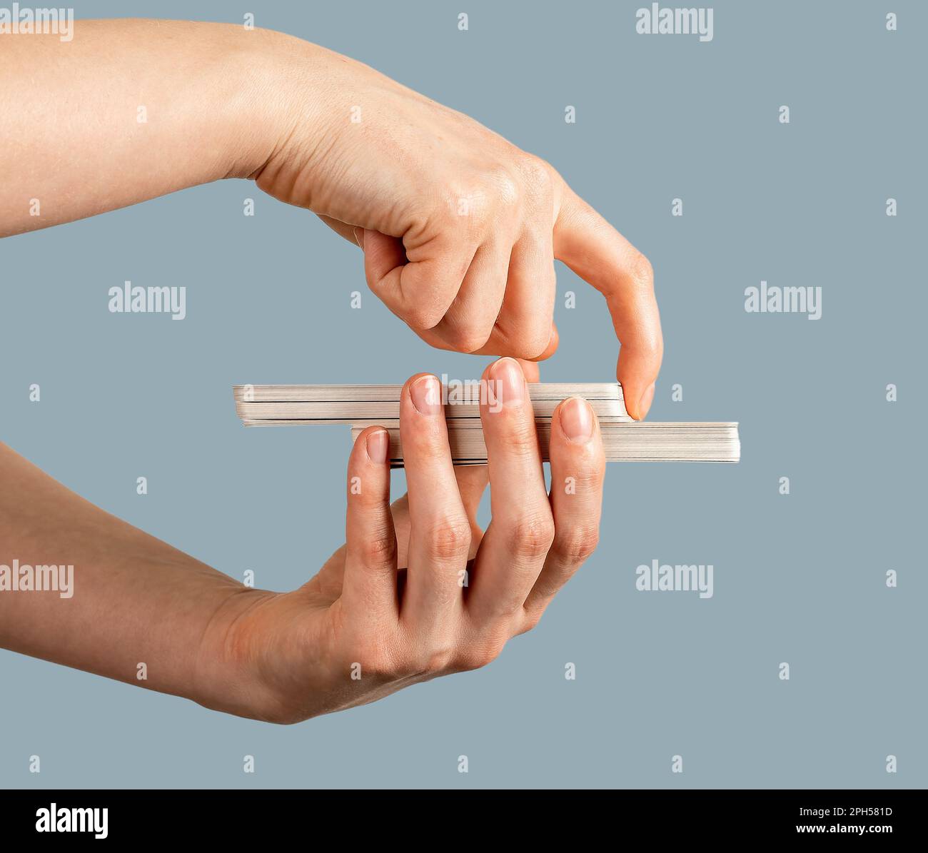 Hand closeup holding tarot deck, cutting part of taro cards, side view