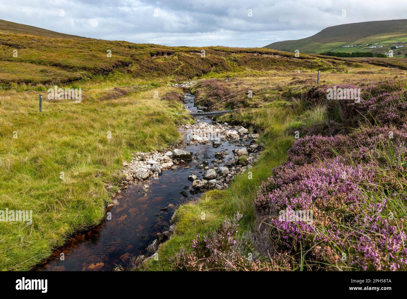 Hiking trail crossing a picturesque brook on the Benwee loop walk, neat Portacloy, County Mayo, Ireland Stock Photo