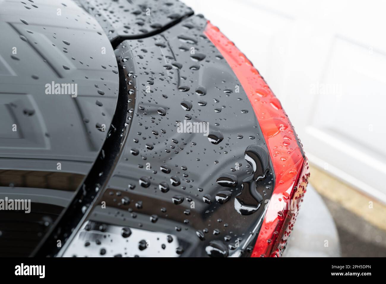 Close-up of the rear light cluster of a modern city car, seen after a car wash. Stock Photo