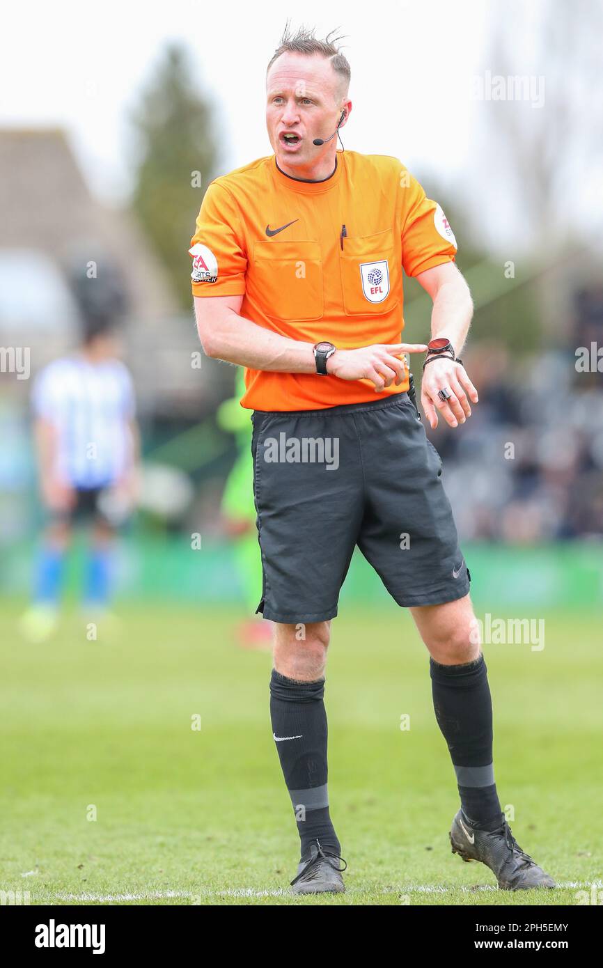 Referee David Rock points at his watch during the Sky Bet League 1