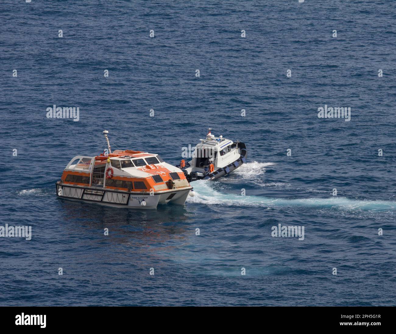 A Direction Des Affaires Maritimes patrol craft, Monaco, halting a tender craft from Cunard liner Queen Elizabeth to allow a sculler or rower to pass. Stock Photo