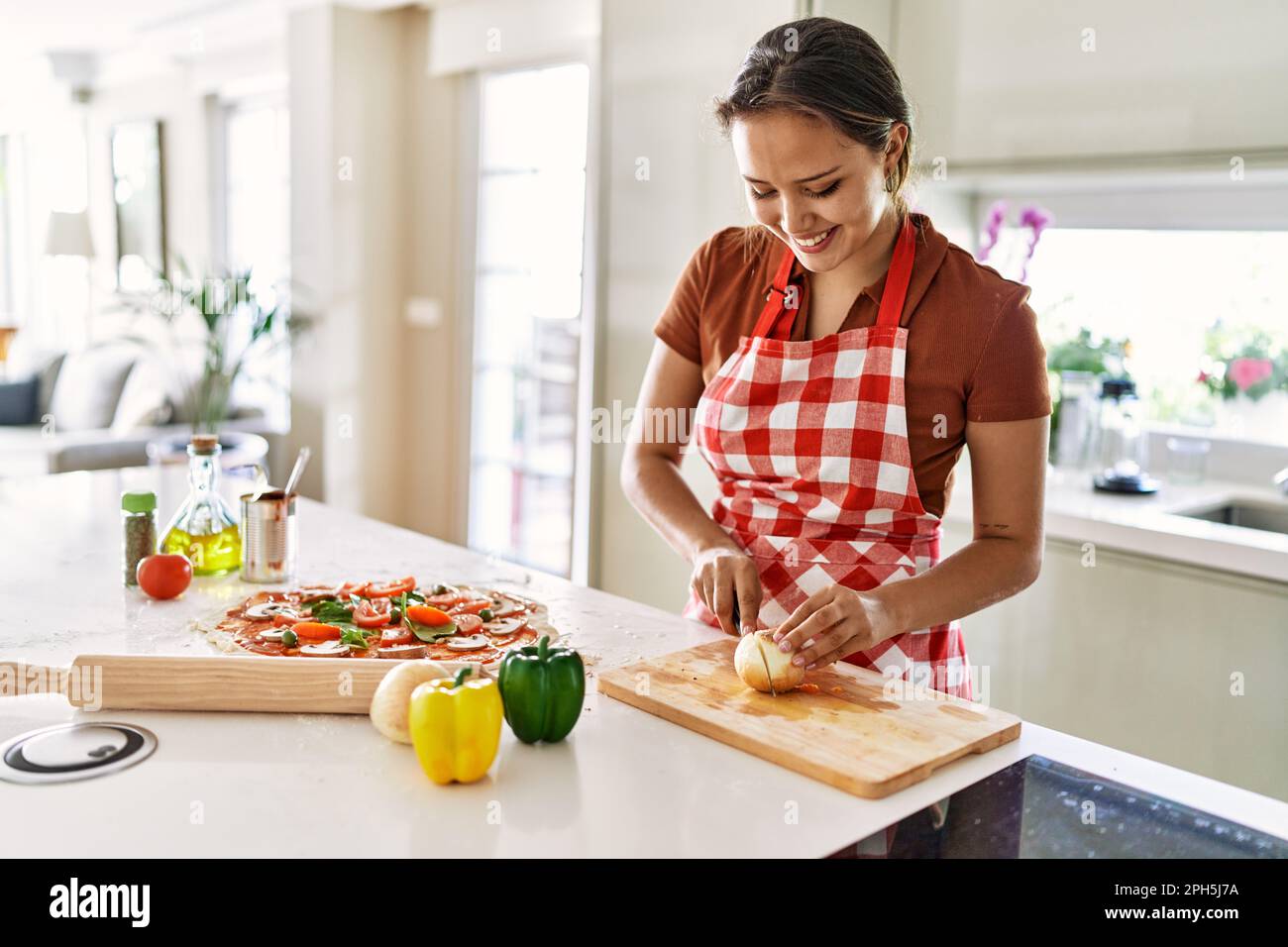 Hispanic woman cutting onion tomato hi-res stock photography and images ...