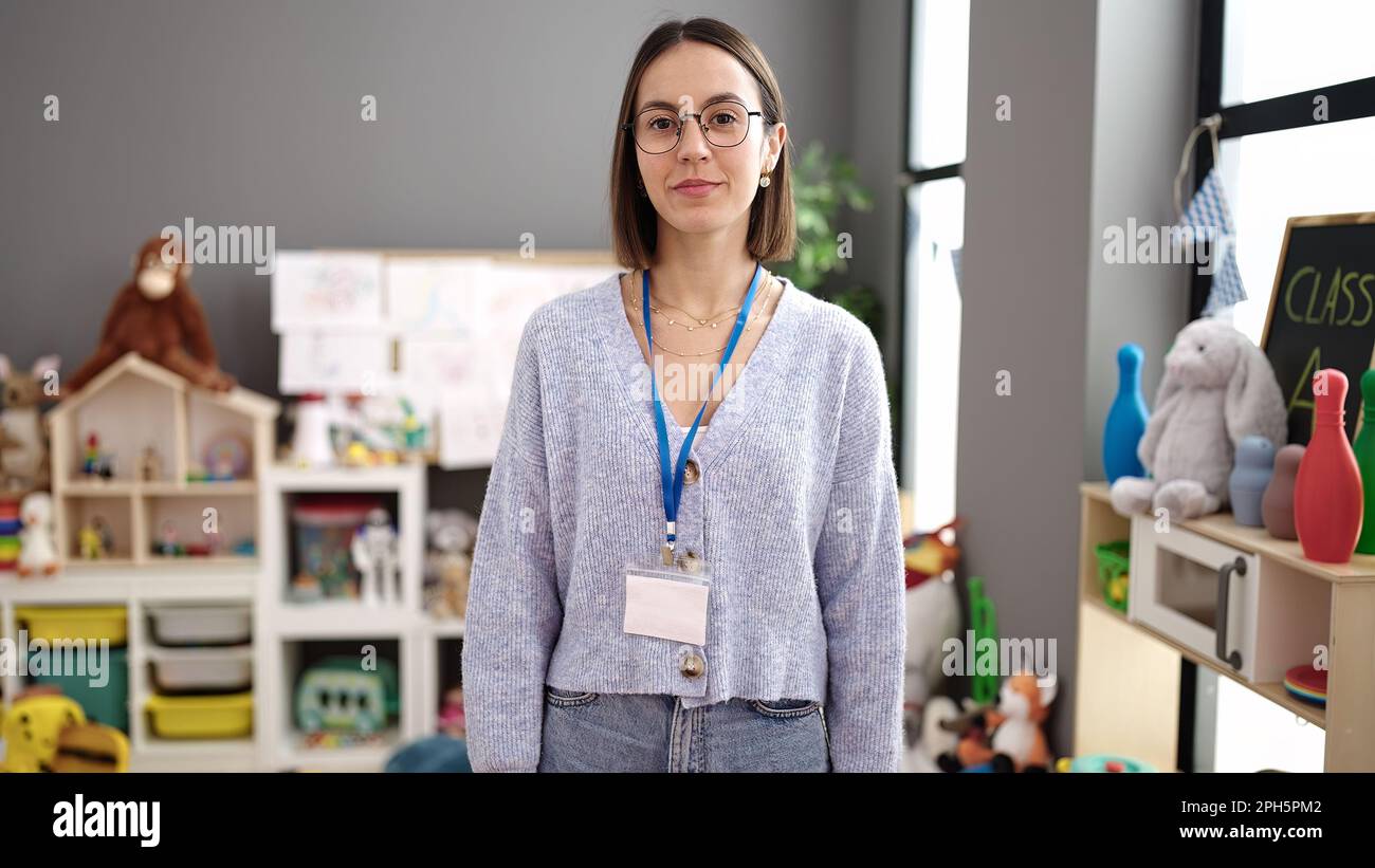 Young beautiful hispanic woman teacher standing with relaxed expression ...
