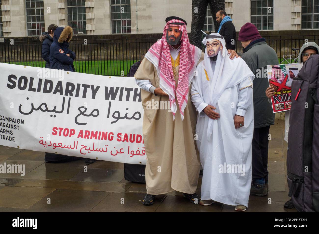 London, UK. 26 Mar 2023. 8 years after the start of the brutal assault on Yemen by Saudi-led forces people stand in a vigil at Downing St organised by CAAT for the thousands who have died, and call for the UK to stop supplying arms. The UN estimates that more than 377,000 had died by the end of 2021 and the UK has supplied arms worth over £23 billion. Two men wear robes and masks of Saudi rulers. Peter Marshall/Alamy Live News Stock Photo