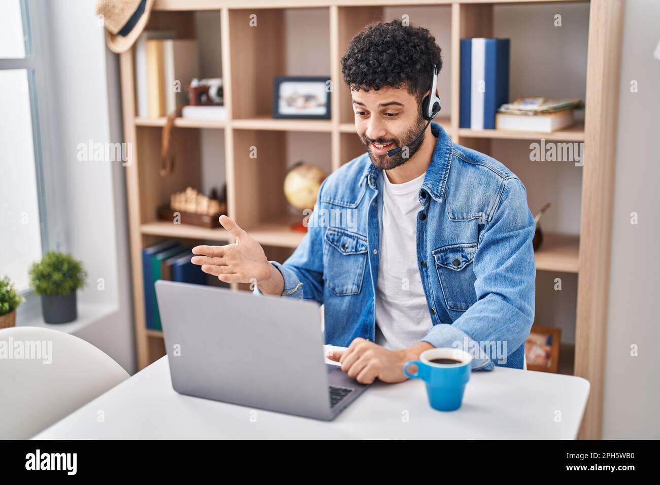 Arab man doing video call using computer laptop celebrating achievement ...