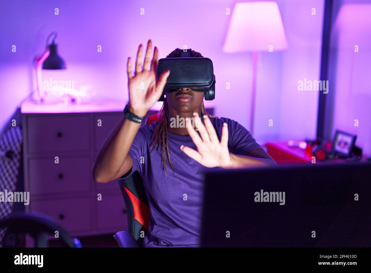 African american woman streamer playing video game using virtual