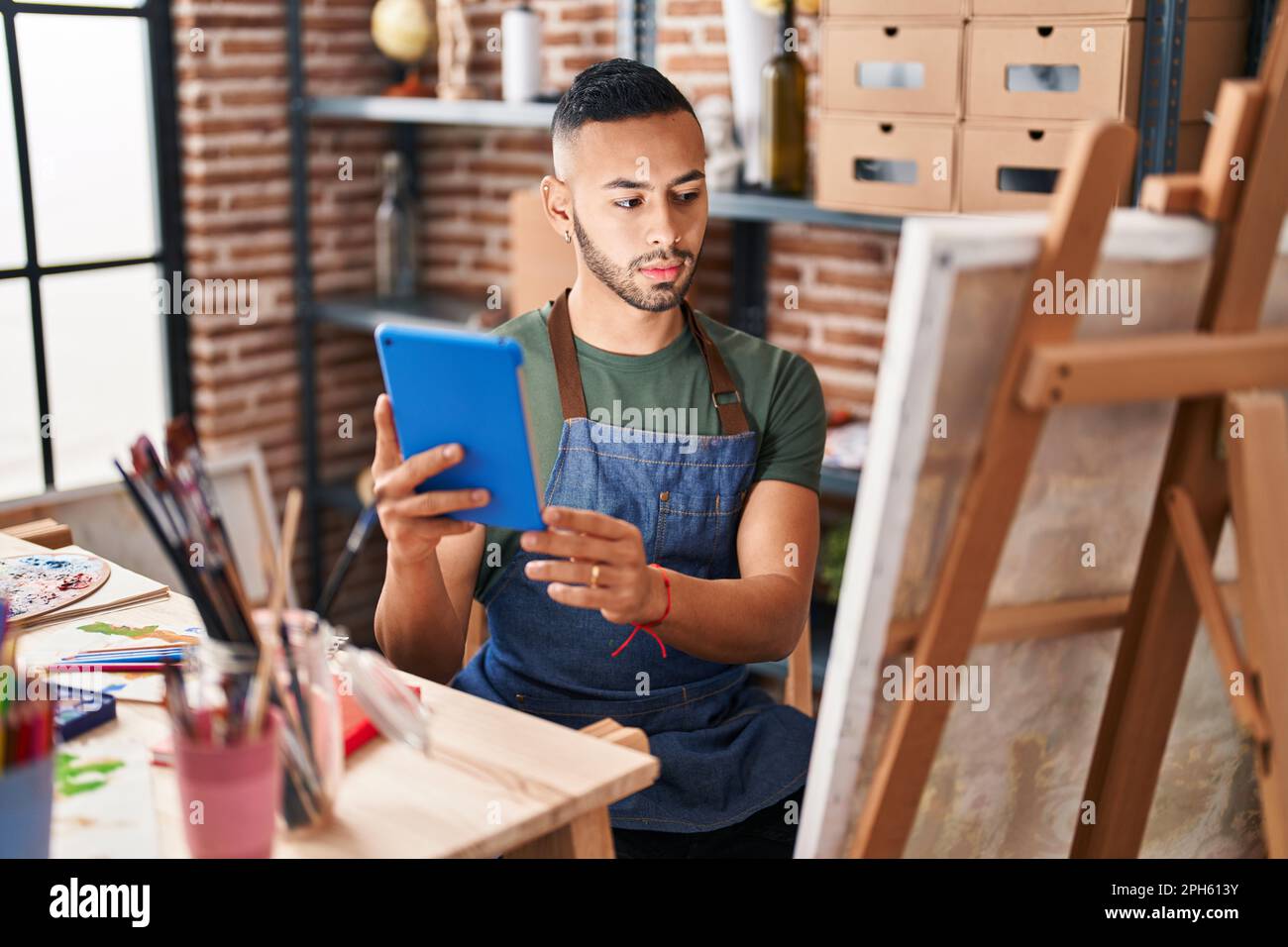 African american man artist using touchpad drawing at art studio Stock