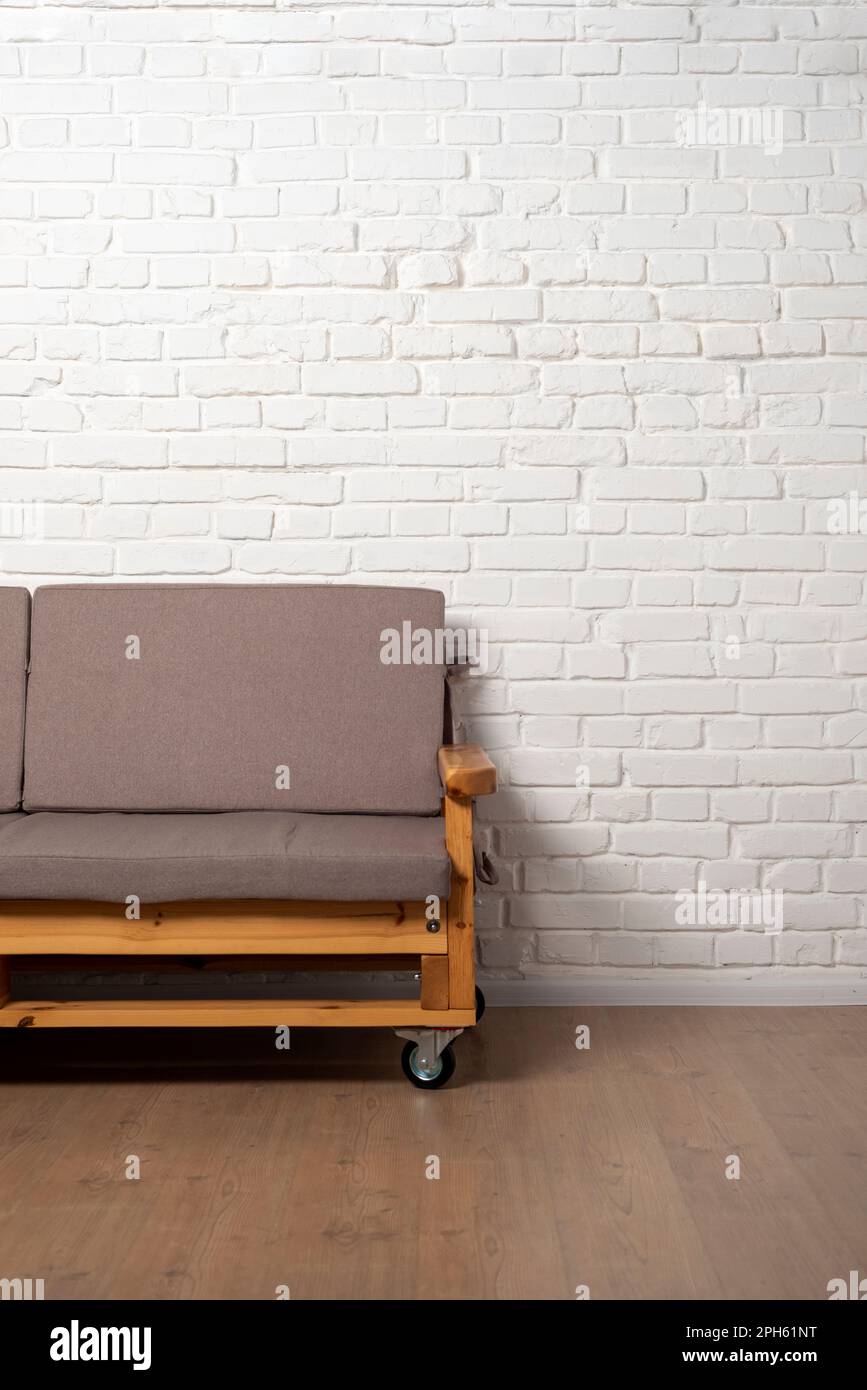 Loft style sofa on white brick wall background Stock Photo