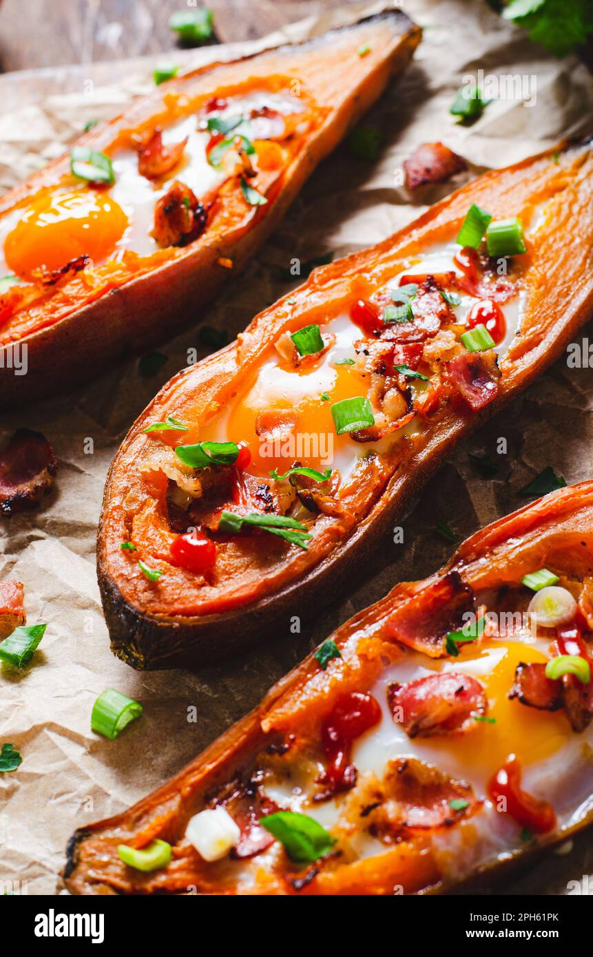 Baked Sweet Potato Stuffed with Egg, Bacon, and Green Onions on Rustic
