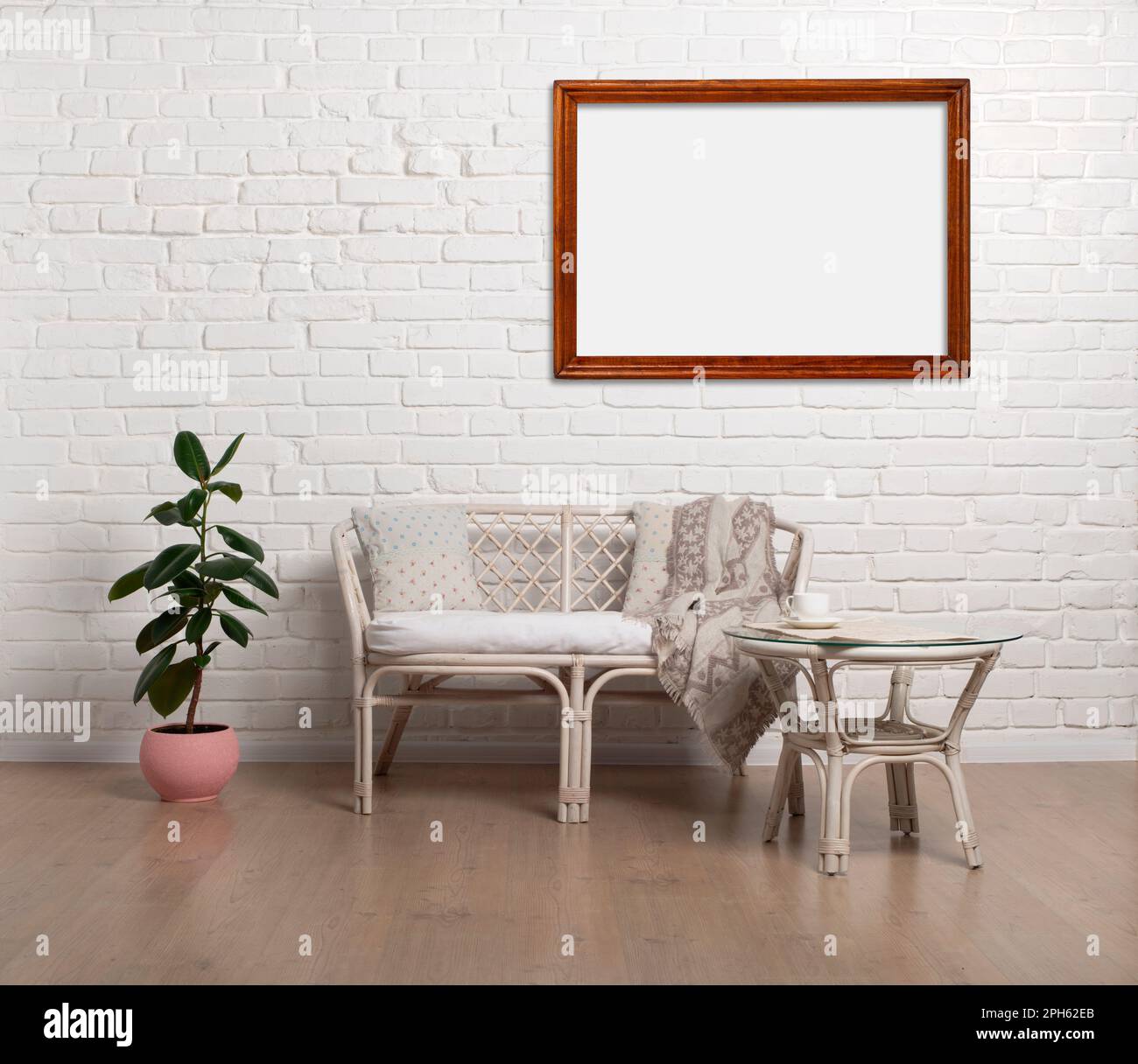 Rattan Living Room Loveseat on white brick wall background with photo frames mockup Stock Photo