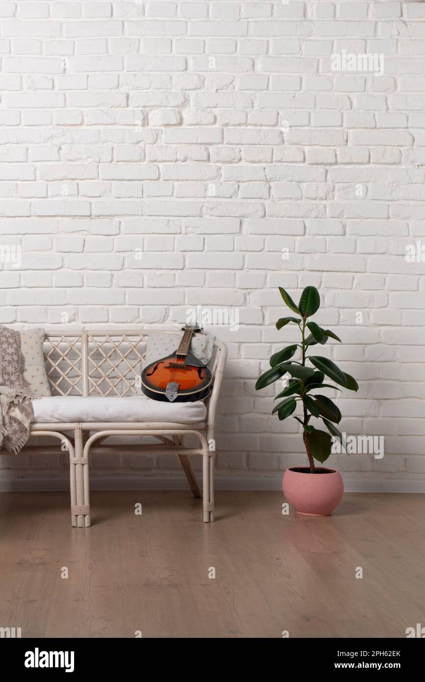 Country style Rattan Living Room Loveseat on white brick wall background Stock Photo